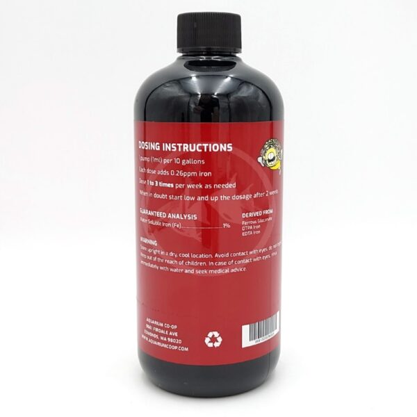 A black bottle with a red label displaying dosing instructions, guaranteed analysis, and warnings for an aquarium product. The label includes text and a logo with a fish illustration in the upper right corner.