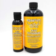 Two bottles of Aquarium Co-Op Easy Potassium supplement are shown. The bottles have yellow labels with white and orange text. The product is for aquarium use and provides potassium.