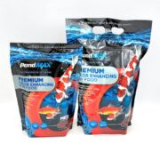 Two bags of PondMAX Premium Color Enhancing Fish Food, featuring colorful koi fish, blue water graphics, and product information. The bags are upright with resealable tops and are designed for koi and goldfish.