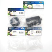 Four PondMAX replacement parts in clear packaging are displayed on a white surface. Each package has a blue and green label with water lily images and product information. The parts inside are black and white plastic.
