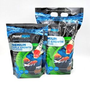 Two blue and black bags of PondMAX Premium Staple Growth Fish Food featuring images of koi fish and water, labeled as specialty food for koi and goldfish. The bags are standing upright on a white surface.