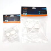 Two TETON branded spare parts in clear plastic packaging, one smaller and one larger, both with blue and orange labels, QR codes, and visible white plastic components inside.