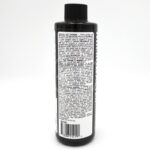 A black bottle with a black cap, shown from the back. The label is densely printed with white text containing directions, guidelines, and product information. A barcode is visible at the bottom of the label.