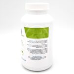 A white plastic bottle with a white cap features a label containing text about the product’s benefits, usage instructions, dosage, and assurance of quality for aquatic environments. The label includes green and blue accent colors.