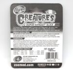 Back of a Zoo Med Creatures Isopod Banquet Block package, displaying product information, feeding instructions, ingredients list, guaranteed analysis, barcode, and company details on a black and white background.
