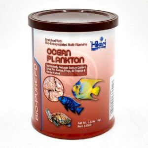 A canister of Hikari Bio-Pure FD Ocean Plankton fish food, featuring images of fish and a turtle on the label. The can is maroon with white and orange text, and is intended for aquatic pets.