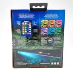 Back of a FLUVAL PRISM 2.0 LED aquarium lighting box showing an infrared remote, multicolor options, feature highlights, and the underwater LED casting vibrant colors into the tank.
