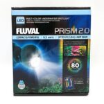 A box of FLUVAL PRISM 2.0 LED, with 6.5 watts, a 6 ft beam, 80 color options, remote control, and vivid aquarium images on the packaging highlights the versatility of the FLUVAL PRISM 2.0 LED Multi-Color Underwater Spotlight.