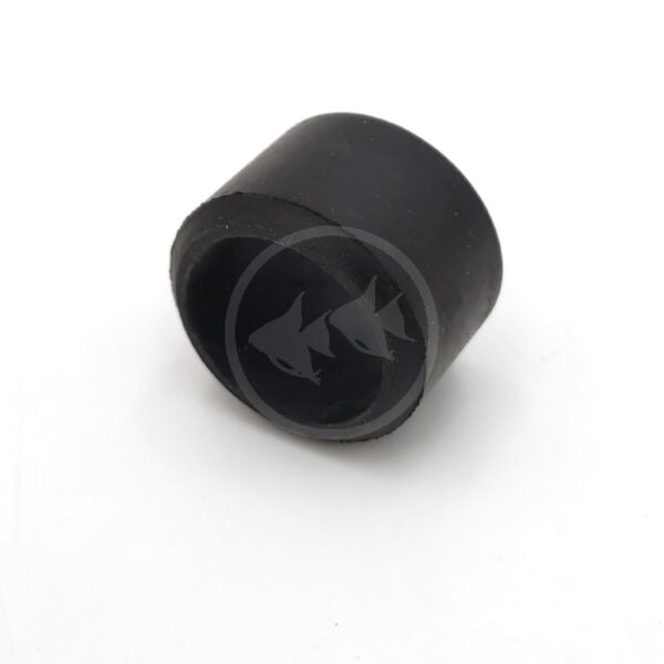 A black, cylindrical rubber cap or stopper with an open end, placed on a white surface.