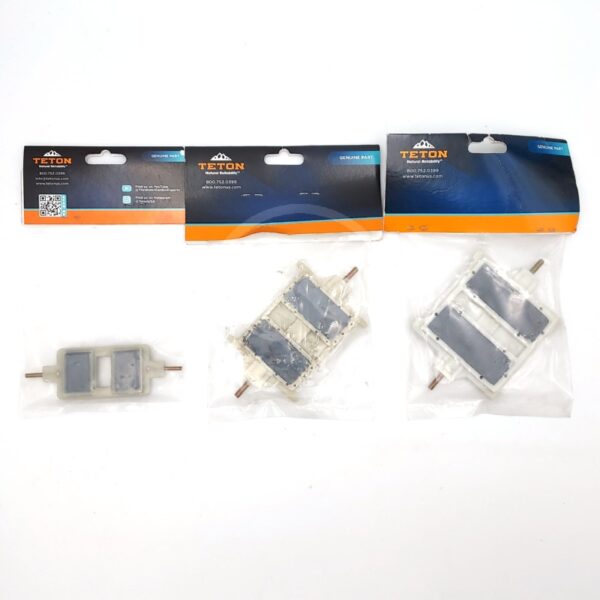Three packaged Teton genuine parts with metal rods and rectangular grey pads, displayed on a white background. The packages have blue and orange labels at the top.