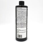 A black plastic bottle with a black cap, featuring a white label covered in dense black text. The label includes feeding instructions, guidelines, and ingredient information for a plant nutrient product.