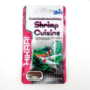 A 10g (.35 oz) packet of HIKARI SHRIMP CUISINE features vibrant shrimp and green algae images, plus pink, silver, and green accents on the packaging—ideal sinking food for freshwater shrimp diets.