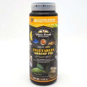 A cylindrical container of Ultra Fresh Shrimp Delight Vegetables Shrimp Pie fish food, featuring images of fish, vegetables, and shrimp on a black label. The container holds 330 ml (145 g) and highlights 25% shrimp content.