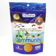 A blue and white pouch of NorthFin Premium Fish Food, Community Formula, featuring images of various fish, a gold seal, and bilingual English and French text. The package weighs 250g (8.8oz).