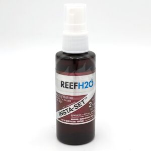 A brown spray bottle labeled REEF H2O Insta-Set Accelerator for CA glues, 2 oz size, with a white spray cap and warning information printed on the lower part of the label.