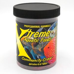 A container of Xtreme Aquatic Foods Community Crave spirulina-krill flakes, featuring colorful images of tropical fish and a black lid. The label highlights Professional Formula.
