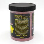 A container of fish food with a black lid, featuring a yellow fish illustration and a detailed label listing ingredients, nutritional analysis, and net weight of 1 oz (28 grams) against a white background.