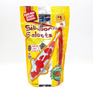 A yellow bag of HIKARI SILKWORM SELECTS TREAT 17.6 OZ fish food shows a large koi image, with red and white text, and labels such as Daily Diet Growth Booster and 50% Silkworm on the packaging.