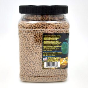 A clear plastic jar with a black lid filled with brown pellet fish food. The label on the jar features feeding instructions, product information, a green fish image, a goldfish image, and a small USA flag icon.