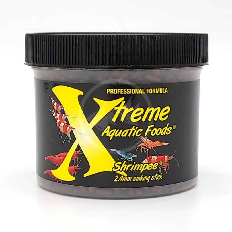 XTREME SHRIMPEE SINKING STICKS 2 8 OZ 79 G FRONT.jpg A black plastic jar labeled Xtreme Aquatic Foods ShrimpE with a yellow X, images of colorful shrimp, and the text Professional Formula and 2.4mm sinking stick on the front.