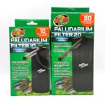 Two green boxes of Zoo Med Paludarium Filters, one for up to 10 gallons and one for up to 20 gallons of water. Both feature images of the filter and a fish, with product details and logos on the packaging.