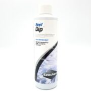 SEACHEM REEF DIP 250ML (8.5 OZ) comes in a white plastic bottle with a white cap and blue-black label featuring coral imagery. This coral disinfectant helps protect your corals from harmful bacteria.