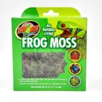 A green box of Zoo Med All Natural Living Frog Moss featuring a colorful frog image, a window showing the moss inside, and text describing the product as decorative, natural moss for terrarium use.