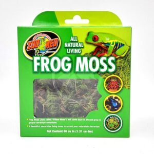A green box of Zoo Med All Natural Living Frog Moss featuring a colorful frog image, a window showing the moss inside, and text describing the product as decorative, natural moss for terrarium use.