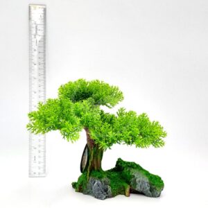 The UT RESIN YOUNG BONSAI TREE features bright green foliage and sits on a rocky base. Shown with a ruler for scale, the bonsai stands about 20 cm tall against a plain white background.