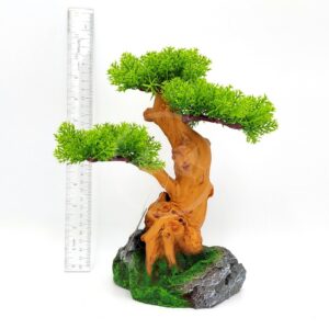 The UT RESIN OLD BONSAI TREE features a small artificial bonsai with bright green leaves and a twisted brown trunk, crafted from UT resin, set on a rock-like base. A clear ruler shows the tree is about 20 centimeters tall.