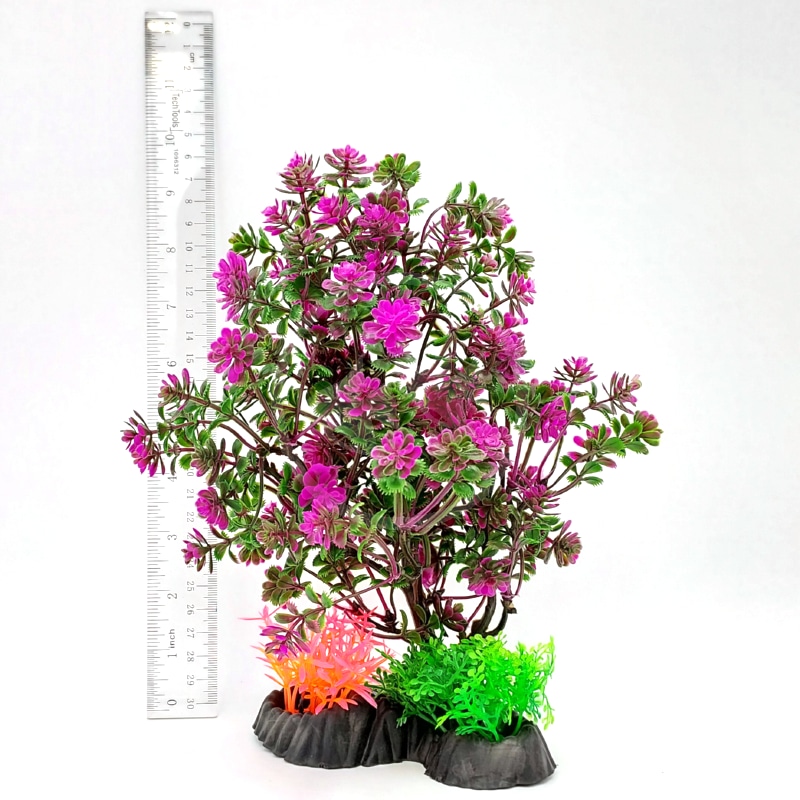 20220927_141223DONE.jpg The PP BONSAI TREE PURPLE 8 BST11 features purple and green leaves with small flower clusters on a black base with orange and green accents. Shown next to a transparent ruler for scale against a white background. Size: 8 inches.