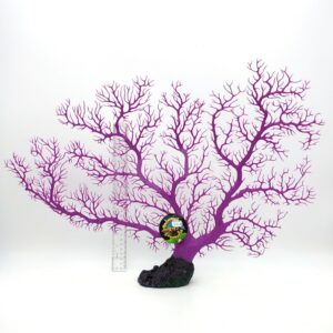 The UT SEA FAN PURPLE artificial coral is mounted on a black base and displayed against a white background. A ruler beside it shows the scale, and a colorful label is attached near the center.