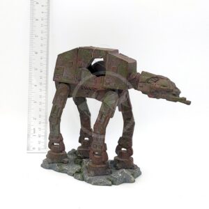 The UT RESIN SPACE BATTLE TANK MD model stands on a rocky base beside a ruler, measuring about 13 cm tall. The weathered model is dark green-brown, resembling a Star Wars space battle tank.