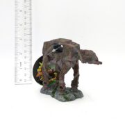 The UT RESIN SPACE BATTLE TANK SM sits on a rocky base next to a vertical ruler for scale, with a round tag in the background. The weathered model measures about 3 inches tall.