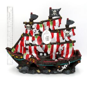The PP RESIN STRIPED SAIL PIRATE SHIP MEDIUM RR960 features red and white striped sails, skull ornaments, and an anchor; shown next to a ruler for scale, the pirate ship measures approximately 8 inches tall.