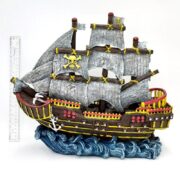 The PP RESIN PIRATE WAVE RUNNER RR963 features tattered gray sails, yellow skull and crossbones, red accents, and an anchor atop blue waves. A ruler stands beside the model pirate ship for scale.