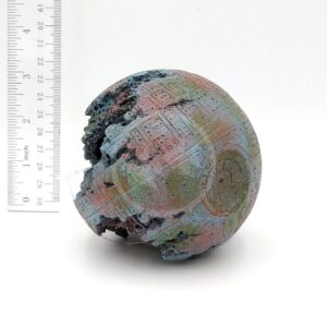 The UT RESIN SPACE BALL is a weathered, 9 cm model resembling the Death Star, shown with a ruler for scale. Its faded paint and partial damage make it look like an underwater treasure preserved in resin.