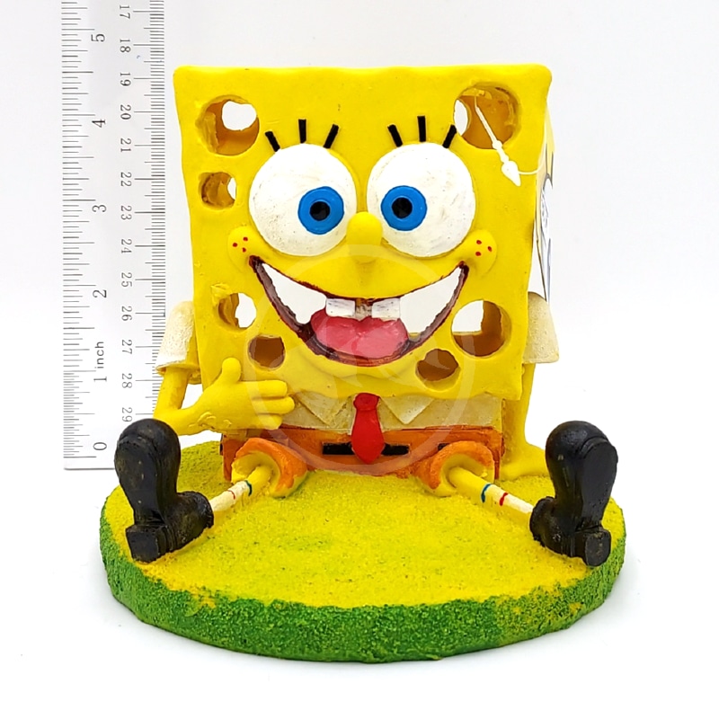 20221017_112732DONE.jpg The PP RESIN SPONGEBOB W SWIM THROUGH HOLES 5 IN is a resin SpongeBob figurine on a yellow-green base, smiling and giving a thumbs up, with swim-through holes and stands about 5 inches tall.