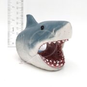 The PP RESIN JAWS SWIM THRU SMALL JWSR1W is a gray and white resin shark head, mouth open with sharp teeth, about 3 inches tall. Great for swim-thru fun in small aquariums. Plain white background with a ruler for scale.