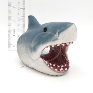 The PP RESIN JAWS SWIM THRU SMALL JWSR1W is a gray and white resin shark head, mouth open with sharp teeth, about 3 inches tall. Great for swim-thru fun in small aquariums. Plain white background with a ruler for scale.