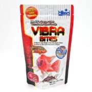 A colorful bag of Hikari Vibra Bites fish food, featuring images of fish, bold red and yellow text, and claims of vibrant color and ideal nutrition for larger fish that prefer live foods.