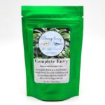 A shiny green pouch labeled Complete Envy Balanced Shrimp Food by Shrimp Envy, featuring a circular logo with shrimp images and text describing it as a wholesome staple food for aquarium shrimp.