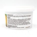 A white plastic container with a label displaying nutritional analysis, ingredients, and manufacturer details for fish food. The text lists protein, fat, vitamins, and various components in small black print.
