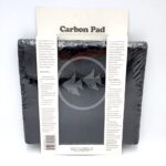 The SEAPORA PAD CARBON 10"X18" package contains two black rectangular pads wrapped in plastic, with a white label showing product details and instructions, plus a logo of two fish.