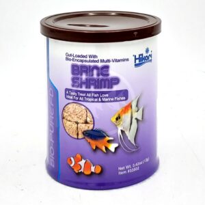 A cylindrical can of HIKARI FREEZE DRIED BRINE SHRIMP .42 OZ (12G) featuring an angelfish, clownfish, and another fish on the label, with a brown lid and purple and blue text and accents.