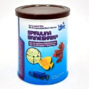 A 0.42 oz (12g) container of HIKARI Freeze Dried Spirulina Brine Shrimp, with images of a yellow tang, blue cichlid, and red betta, highlights its multi-vitamin content and benefits for tropical and marine fish.