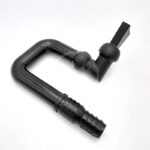 A black plastic L-shaped hose connector with ribbed ends and a lever valve, used for joining and controlling fluid flow in tubing systems, placed on a white background.