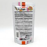 Back of a white and silver food pouch with Japanese text, a barcode, nutritional information, and an illustration of wheat. The packaging features black, red, and yellow accents.