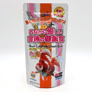 A silver and white package of Hikari Goldfish Wheat-Germ fish food with Japanese text, an image of a goldfish, and colorful labels. The package is upright with a resealable top.