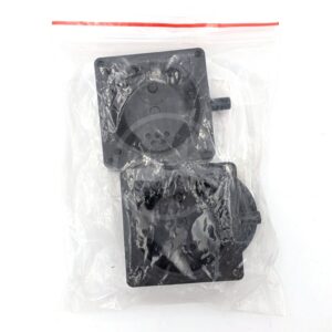 Two black plastic mechanical parts are packaged together in a transparent resealable plastic bag against a white background. The parts have circular and square shapes with visible connectors and holes.